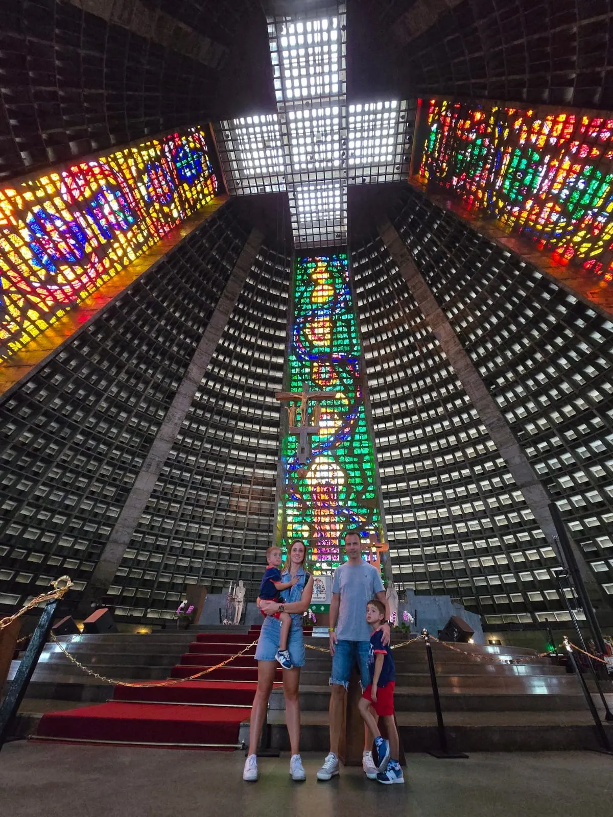 Visitors inside Rio’s Metropolitan Cathedral beneath its stained-glass windows