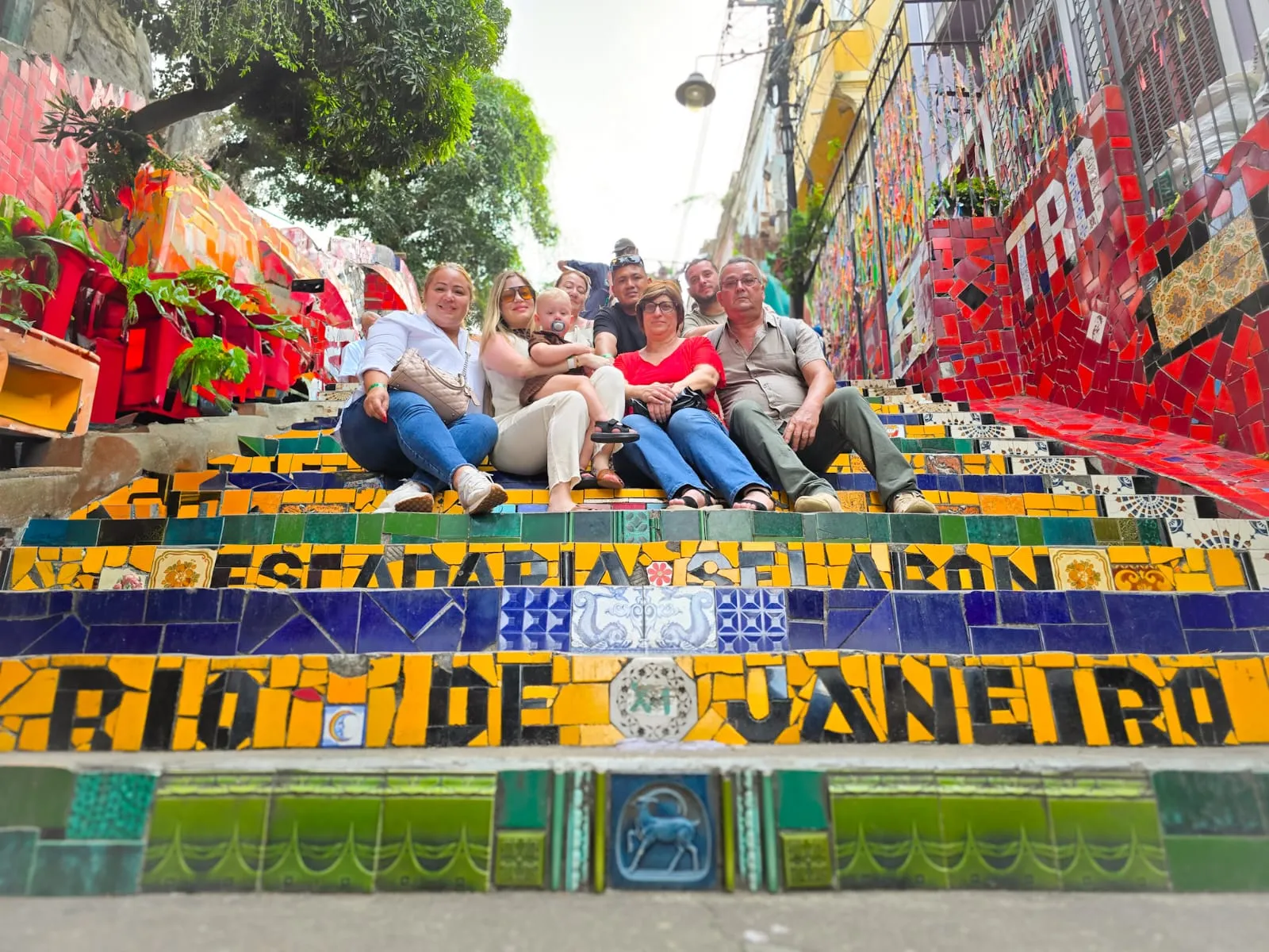Visitors seated on the colorful Selarón Steps in Rio de Janeiro