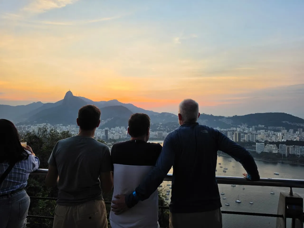 People looking across Rio toward Christ the Redeemer at dusk